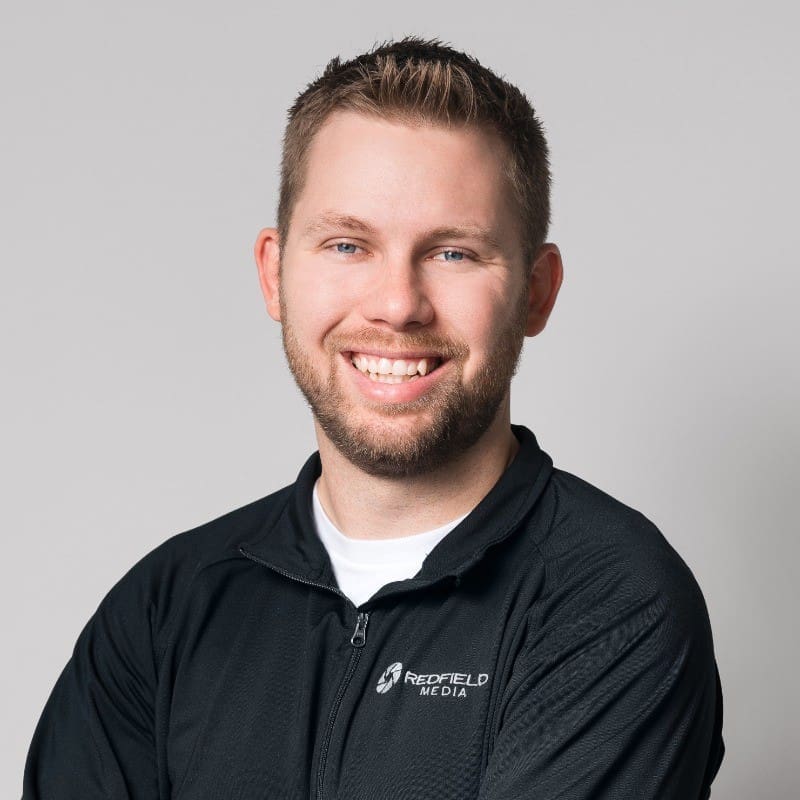 Rich Grossman Portrait of Rich Grossman, owner of Redfield Media, wearing a black jacket with the company logo.